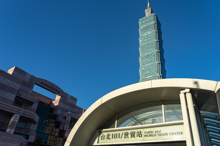 Taipei 101 world trade center metro station street view, with Taipei101 skyscraper building over dark blue sky.のeditorial素材
