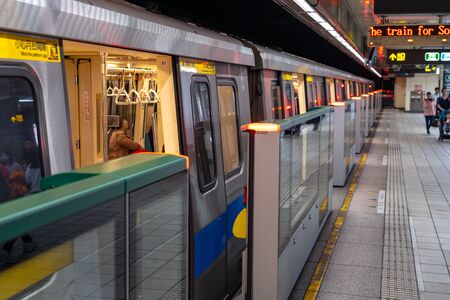 Taipei metro station hall and platform. Subway passengers walk through the enormous underground network of the Taipei Metro system.のeditorial素材