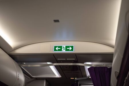 EXIT Lightbox signage on airplane, escape way of life. Concept Way to surviveの写真素材