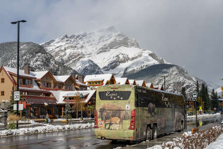 Street view of Town of Banff. Bus stop in Banff Avenue in autumn and winter snowy season. Banff, Alberta, Canada.のeditorial素材