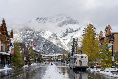 Street view of Banff Avenue in autumn and winter snowy season sunny day during covid-19 pandemic period. Banff, Alberta, Canada.のeditorial素材