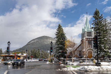 Street view of Banff Avenue in autumn and winter snowy season sunny day during covid-19 pandemic period. Banff, Alberta, Canada.のeditorial素材
