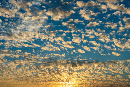 Colorful altocumulus clouds at dusk. Beautiful natural scenery background.の写真素材