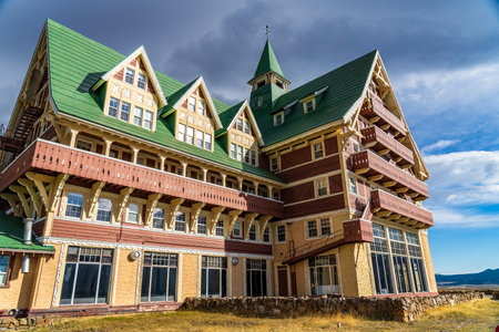 Prince of Wales Hotel in autumn sunny day morning. Blue sky, white clouds over mountains in the background. Landmarks in Waterton Lakes National Park, Alberta, Canada.のeditorial素材