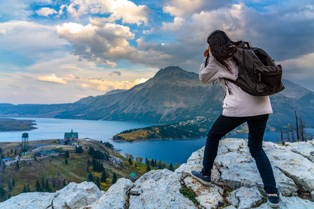 Tourists taking pictures on Town of Waterton Lakes National Park in beautiful dusk. Landscape scenery in autumn foliage season. Alberta, Canada.の写真素材