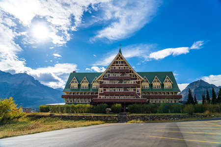 Prince of Wales Hotel in autumn sunny day morning. Blue sky, white clouds over mountains in the background. Landmarks in Waterton Lakes National Park, Alberta, Canada.のeditorial素材