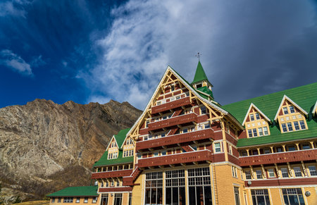Prince of Wales Hotel in autumn sunny day morning. Blue sky, white clouds over mountains in the background. Landmarks in Waterton Lakes National Park, Alberta, Canada.のeditorial素材