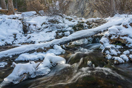 Icy creek flowing in winter season. Grassi Lakes, Canmore, Alberta, Canada.の写真素材