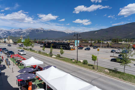 Jasper, Alberta, Canada-June 17 2021: Town Jasper street view in summer during covid-19 pandemic period. People seating sidewalk dining outside the restaurants.のeditorial素材