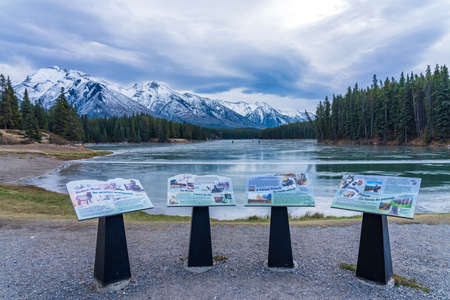 Johnson Lake frozen water surface in winter time. Snow-covered mountain in the background. Tourists here doing ice-skating in this season. Banff National Park, Canadian Rockies, Alberta, Canada.のeditorial素材