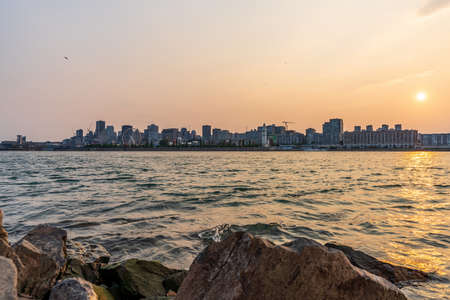View of downtown Montreal city skyline and Saint Lawrence River at sunset, Quebec, Canada.の写真素材