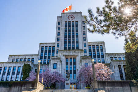 BC, Canada-March 25 2021: Vancouver City Hall with cherry blossoms in full bloom. Canada spring time season photography.のeditorial素材