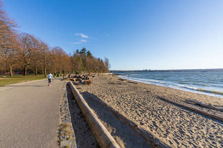 Vancouver, BC, Canada-MAR 16 2021: Second Beach, Stanley Park Seawall in sunny day.の写真素材