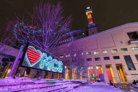 Mississauga, Ontario, Canada-December 18 2021: Mississauga City Hall winter night illumination. Celebration Square Ice Skating Rink.のeditorial素材
