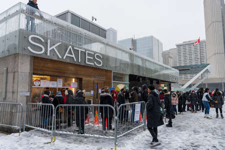 Toronto, Ontario, Canada-December 18 2021: People doing ice skating at Nathan Phillips Square in winter day during covid-19 pandemic period.のeditorial素材