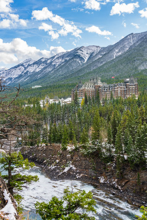 Fairmont Banff Springs and Bow River Falls in snowy autumn sunny day. View from Surprise Corner Viewpoint. Banff National Park, Canadian Rockies.のeditorial素材