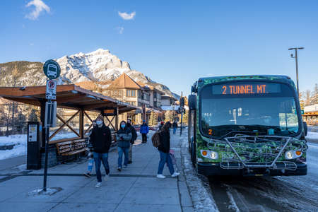 Banff, Alberta, Canada - January 23 2022 : Street view of Town of Banff. Bus stop on Banff Avenue in winter snowy season.のeditorial素材