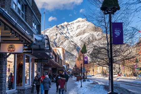 Banff, Alberta, Canada - January 23 2022 : Tourists shopping on Banff Avenue in winter.のeditorial素材