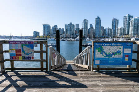 Vancouver, BC, Canada - April 16 2021 : Vancouver marina, False Creek Ferry Dock, modern buildings skyline in the background.のeditorial素材