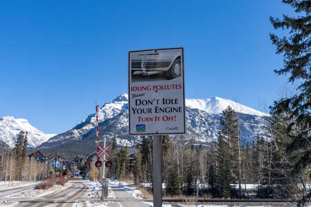 Canmore, AB, Canada - Feb 25 2022 : Outdoor parking rules. Idleing pollutes. Dont't idle your engine turn it off road sign.のeditorial素材