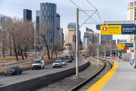 Calgary, AB, Canada - March 14 2022 : Bridgeland Memorial station platform. CTrain light rail system. Traffic on Memorial Drive.のeditorial素材