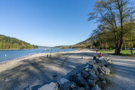 Burnaby, BC, Canada - April 18 2021 : Barnet Marine Park in a sunny day. Burrard Inlet shore.のeditorial素材
