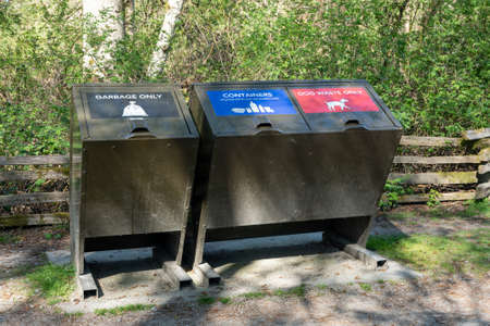 Garbage bin for garbage only and containers and dog waste only. Trash container in public park.のeditorial素材