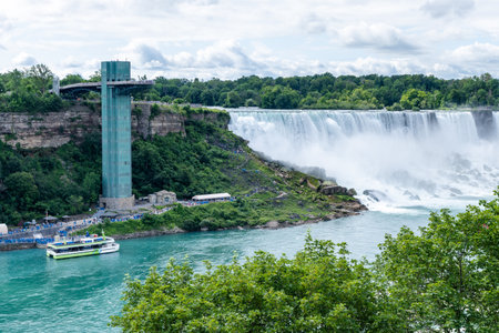 Niagara Falls, Ontario, Canada - July 10 2021 : Maid of the Mist USA Boat Tour. Niagara Falls Observation Tower. American Falls.のeditorial素材