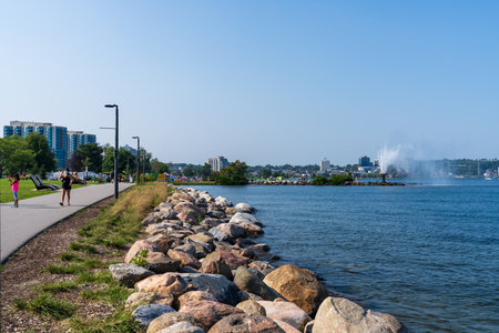 Barrie, Ontario, Canada - July 25 2021 : Walking Path on shore of Kempenfelt Bay, Lake Simcoe in summer time. Centennial Park Waterfront Fountain.のeditorial素材