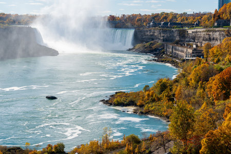 Overlooking the Niagara Falls Horseshoe Falls in a sunny day in autumn foliage season. Niagara Falls City, Ontario, Canada.の写真素材