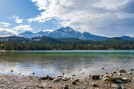 Lake Annette lake shore beach, Pyramid mountain reflection on the lake. Jasper National Park stunning nature scenery in summer time. Landscape of Canadian Rockies, Alberta, Canada.の写真素材