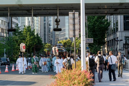 Osaka, Japan - July 25 2023 : Tenjin Matsuri Festival. People wearing traditional clothes walking...