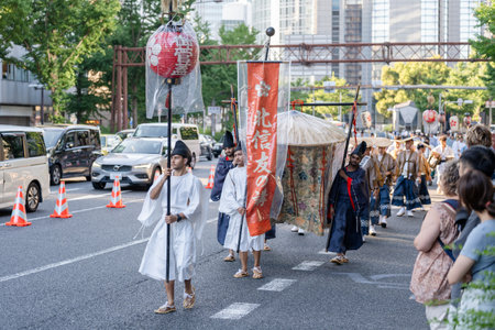 Osaka, Japan - July 25 2023 : Tenjin Matsuri Festival. People wearing traditional clothes walking through the streets.のeditorial素材