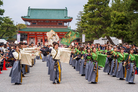 Kyoto, Japan - March 31 2024 : Kyoto Sakura Yosakoi ( Sakuyosa ) festival. A group of dancers dancing down a street at the Okazaki area around Heian Shrine.のeditorial素材