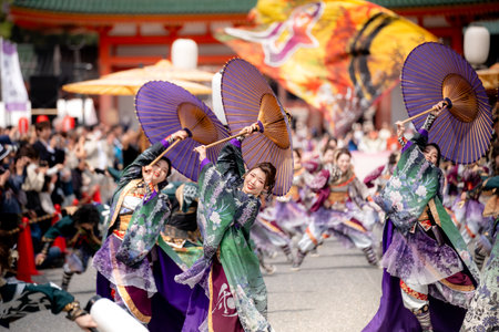 Kyoto, Japan - March 31 2024 : Kyoto Sakura Yosakoi ( Sakuyosa ) festival. A group of dancers dancing down a street at the Okazaki area around Heian Shrine.のeditorial素材