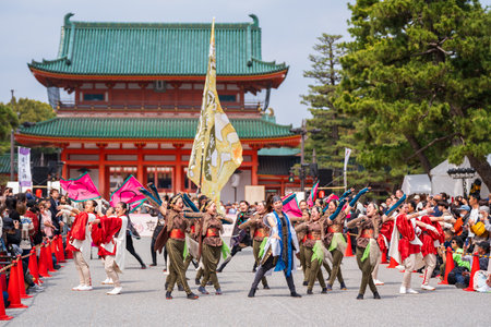 Kyoto, Japan - March 31 2024 : Kyoto Sakura Yosakoi ( Sakuyosa ) festival. A group of dancers dancing down a street at the Okazaki area around Heian Shrine.のeditorial素材