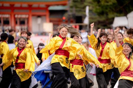 Kyoto, Japan - March 31 2024 : Kyoto Sakura Yosakoi ( Sakuyosa ) festival. A group of dancers dancing down a street at the Okazaki area around Heian Shrine.のeditorial素材