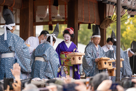 Kyoto, Japan - February 2 2024 : Yasaka Shrine Setsubun festival roasted beans scattering ceremony "mamemaki". Maiko throwing the fortune beans.のeditorial素材