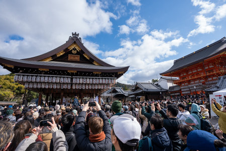 Kyoto, Japan - February 2 2024 : Yasaka Shrine Setsubun festival roasted beans scattering ceremony "mamemaki". Shrine staff throwing the fortune beans.のeditorial素材