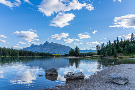 Two Jack Lake beautiful landscape in summer day. Mount Rundle with blue sky, white clouds reflected on water surface. Banff National Park, Canadian Rockies, Alberta, Canada.の写真素材