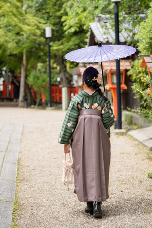Unidentified woman wearing Hakama with a japanese style umbrella.の写真素材