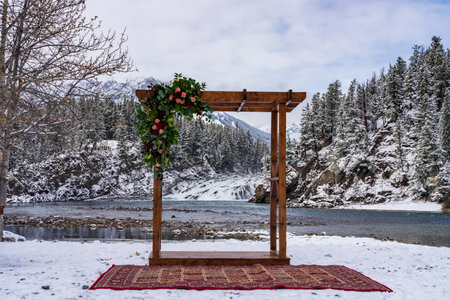 An artistic wooden pavilion decoration and Bow Falls in the background in winter. A concept of marriage. Banff National Park, Bow River.の写真素材