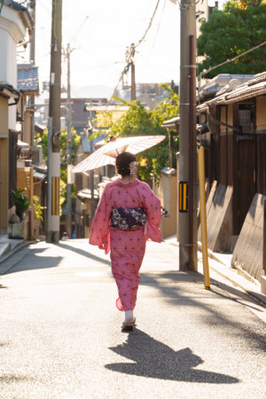 Young woman walking on the street in japanese kimonoの写真素材