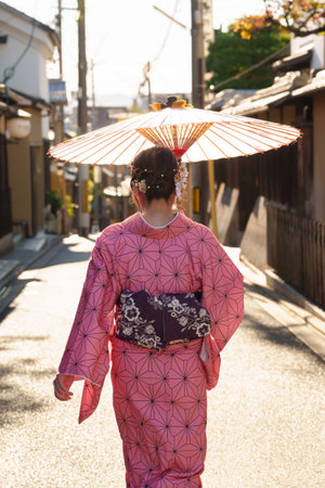 Japanese woman wearing kimono walking in a street in Kyoto, Japanの写真素材