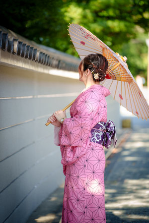 Japanese girl in a kimono with a parasol in the parkの写真素材