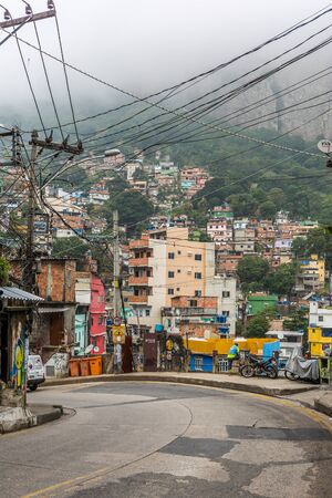 A street view of a winding road that runs down and through Rocinha favela, a shanty town or slum in Rio de Janeiro, Brazil, South Americaのeditorial素材