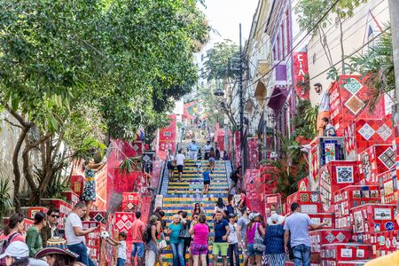 A crowd of tourists gather at the bottom of the Lapa steps in the cool, colorful and urban Lapa neighbourhood of central Rio de Janeiro in Brazil, South Americaのeditorial素材