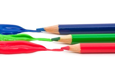 Red, green and blue color flowing out of pencils over white backgroundの写真素材