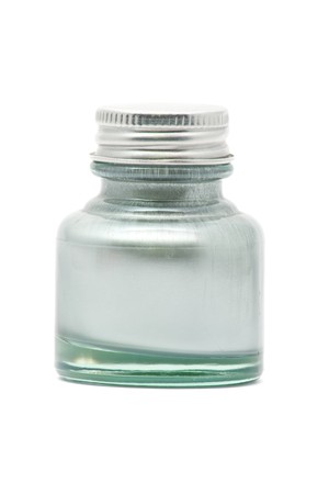Silver ink in inkwell over white backgroundの写真素材