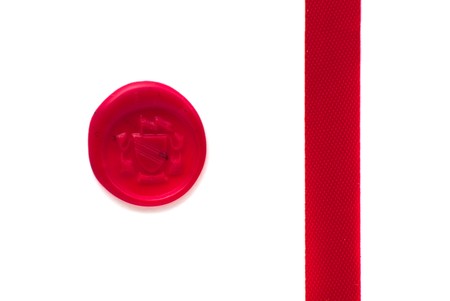 Red wax seal and ribbon over white backgroundの写真素材